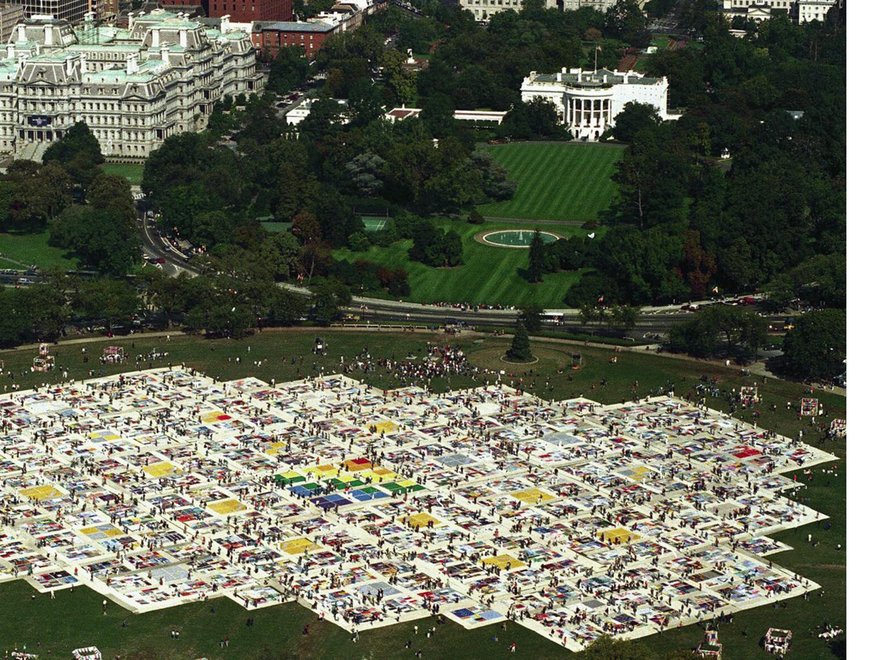 The AIDS Memorial Quilt laid out on the Ellipse Washington D.C. in 1988, spanning the size of a large field.