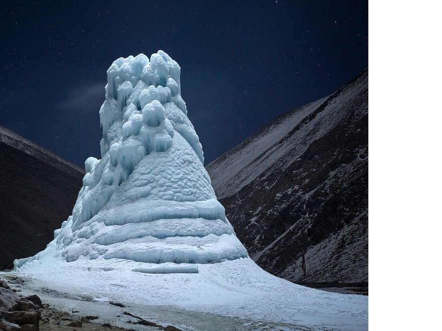 A natural tower of ice against a dark background