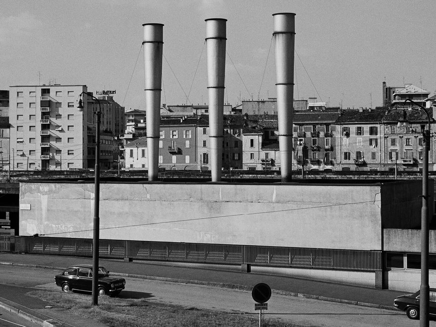 Black and white photo of a road and billboard in Milan