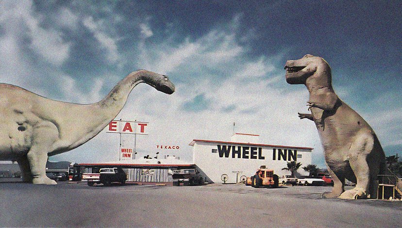 A vintage photo showing the Cabazon Dinosaurs attraction in Cabazon, California, featuring large statues of a Brontosaurus (Dinny) and a Tyrannosaurus Rex in front of the Wheel Inn restaurant and a Texaco gas station.
