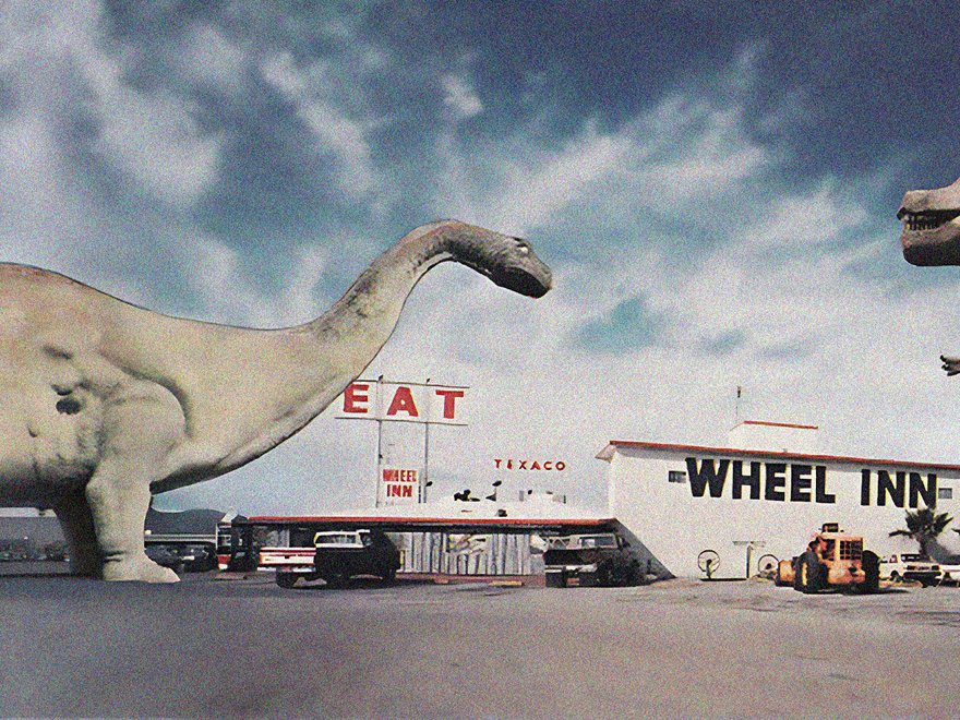 A vintage photo showing the Cabazon Dinosaurs attraction in Cabazon, California, featuring large statues of a Brontosaurus (Dinny) and a Tyrannosaurus Rex in front of the Wheel Inn restaurant and a Texaco gas station.