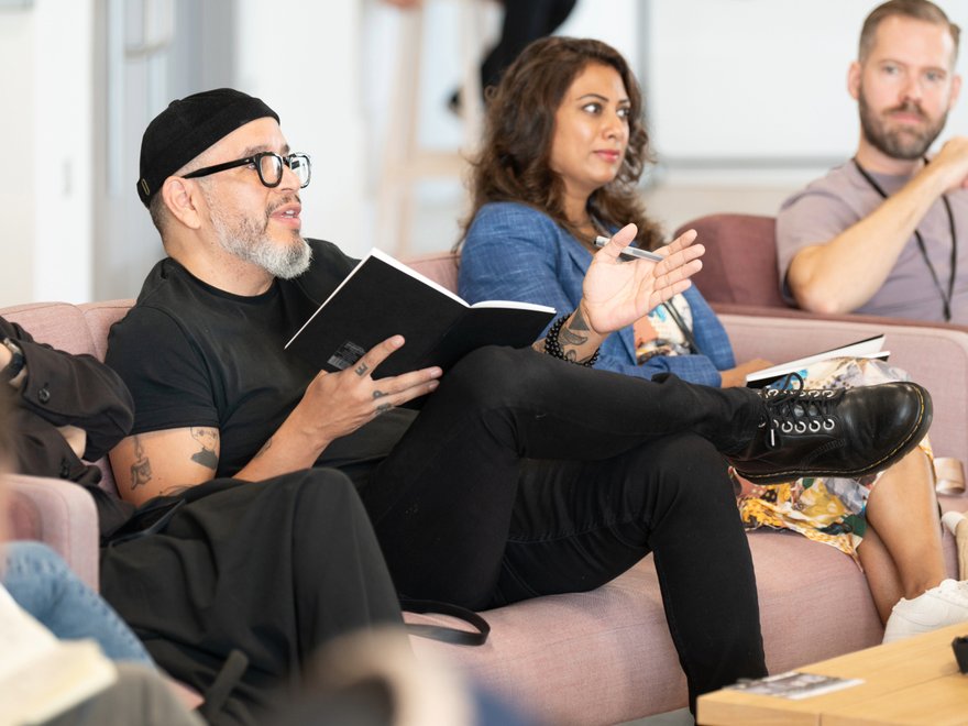 A group of people sit in a discussion
