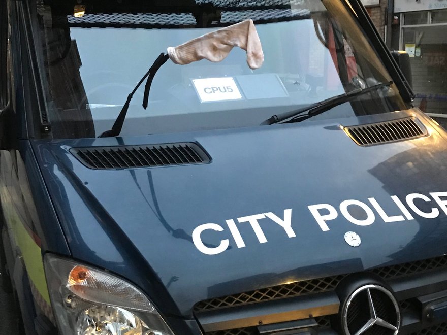 A police van with a dirty sock on it