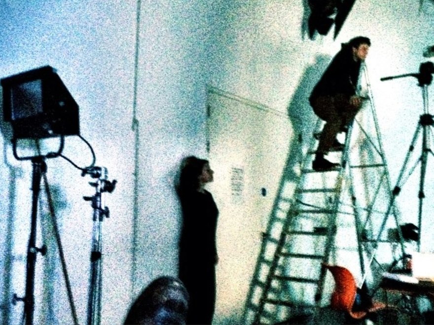 a grainy image of people in a film studio