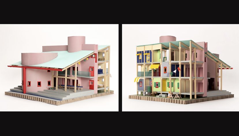 The model depicts a multi-story building with a light pink exterior and a light blue slanted roof.