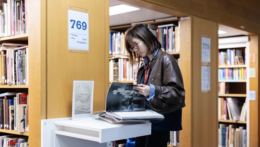 A Student flicking through an art book