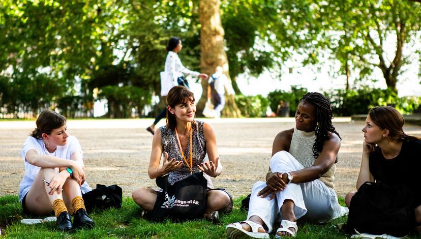 Group of participants sit in one of the london parks discussing one of the group activities