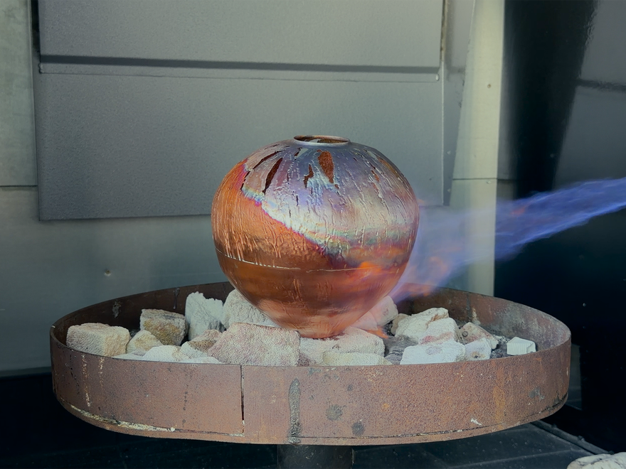 large metal vessel being flamed with a blow torch