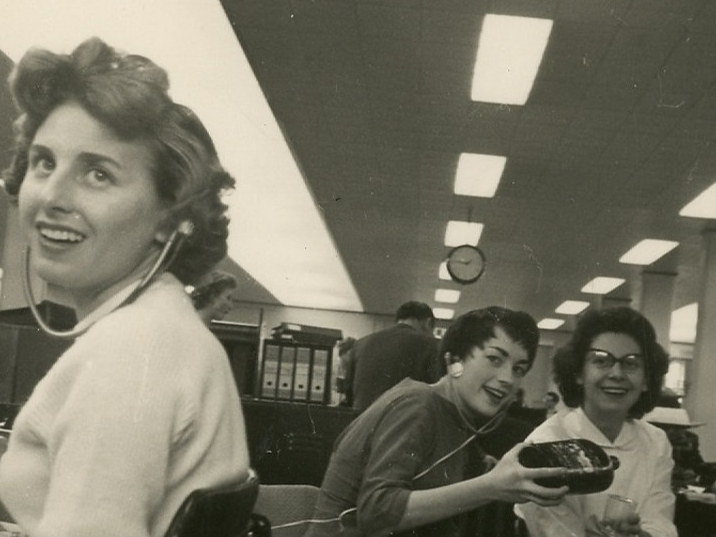Bonny and two colleagues sat at their desks with their headphones in from her time working as a typist at Ilford Limited, circa 1960s