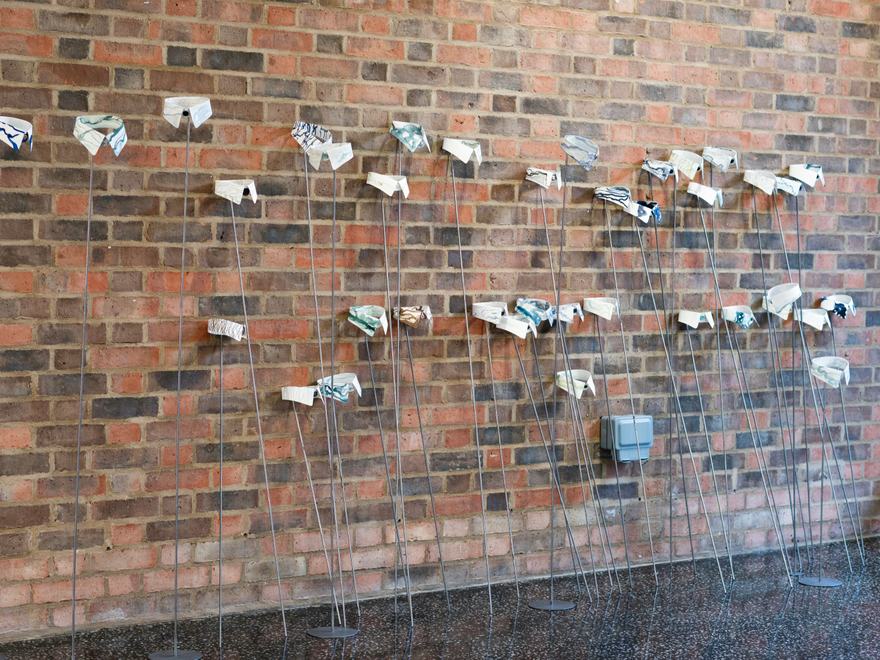 a sculpture of pages on sticks