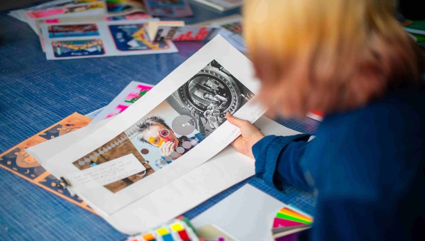 A student examines a selection of colourful prints