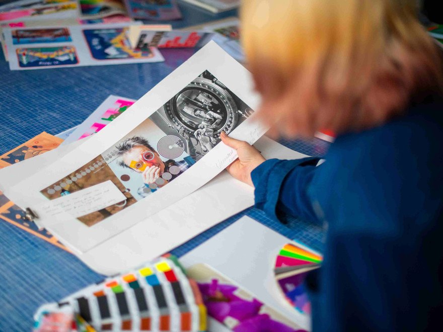 A student examines a selection of colourful prints