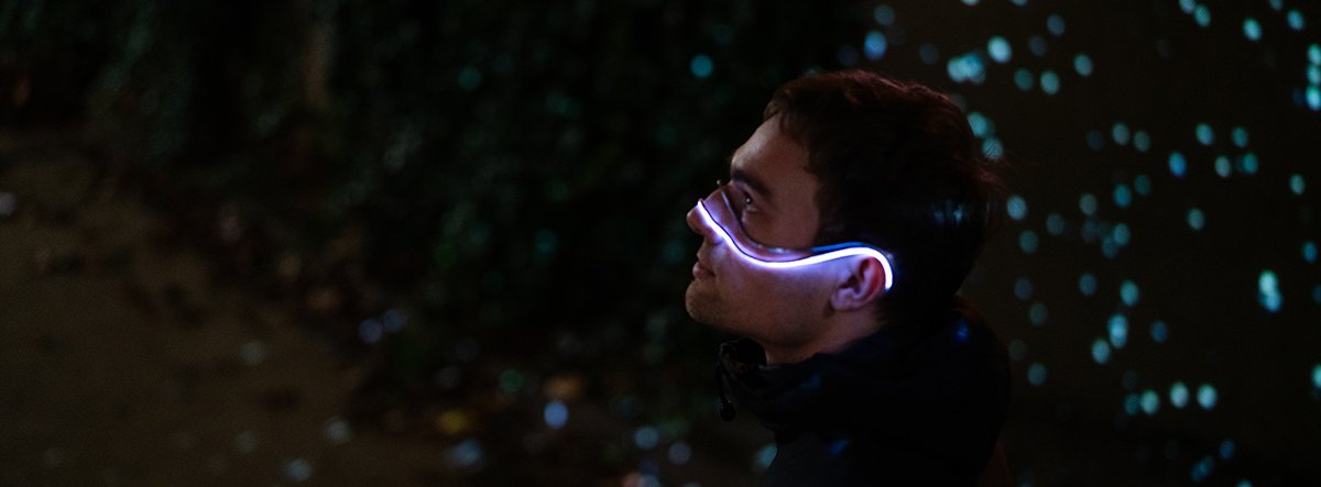 A man poses with the light up Starsight device hung over the bridge of his nose