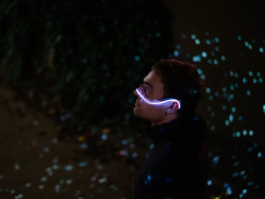 A man poses with the light up Starsight device hung over the bridge of his nose