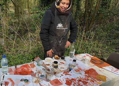 Royal College of Art MFA student at table with painting materials