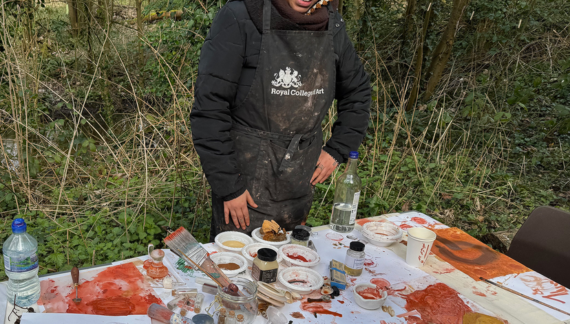 Royal College of Art MFA student at table with painting materials