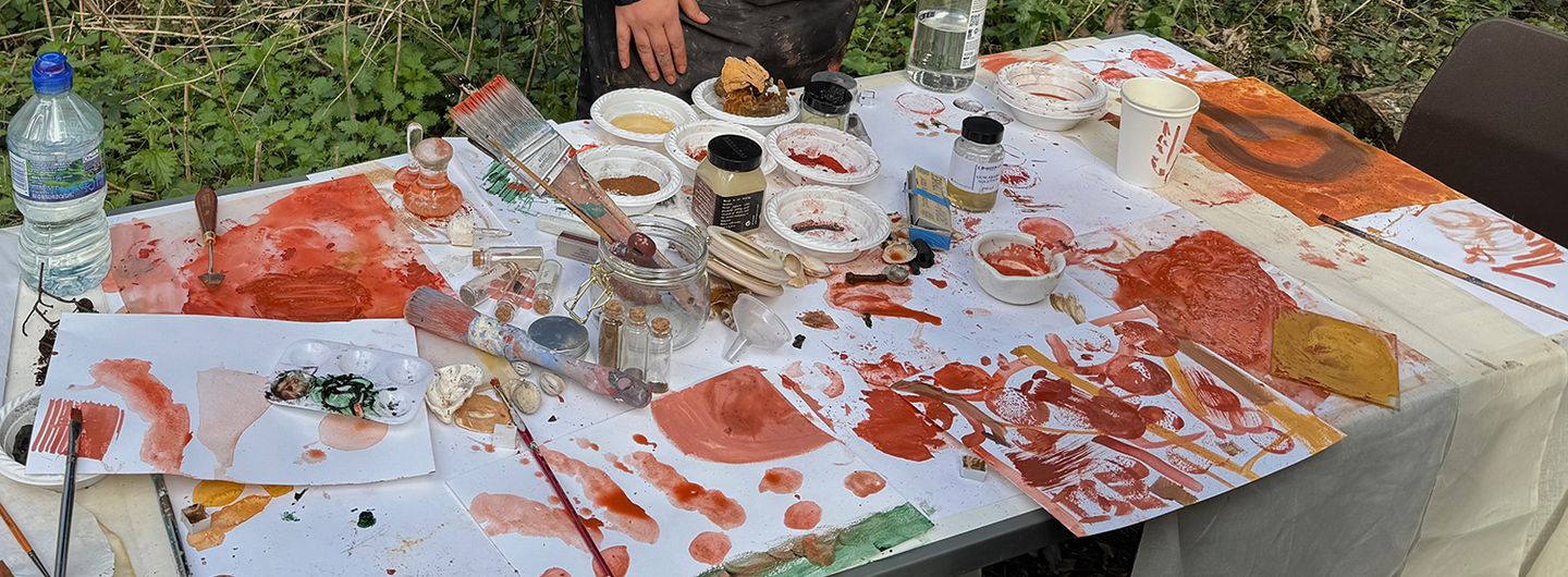 Royal College of Art MFA student at table with painting materials