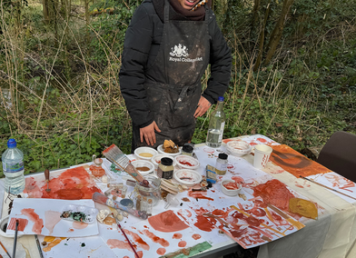 Royal College of Art MFA student at table with painting materials