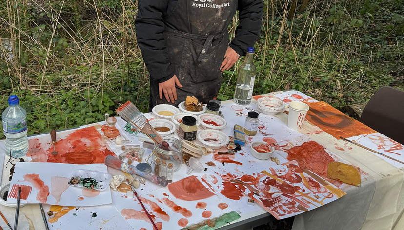 Royal College of Art MFA student at table with painting materials