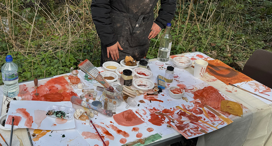 Royal College of Art MFA student at table with painting materials