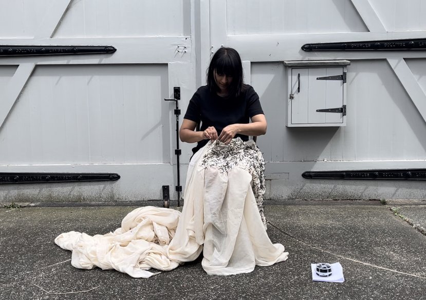 Image from a durational performance at Beaconsfield Gallery, June 2022. Sprigged – A Million Little Cuts. Muslin, garden twist ties, chair.