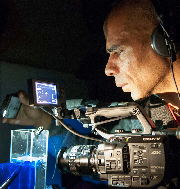 RCA PhD Candidate Wayne Binitie documenting Antarctic ice at the British Antarctic Survey (Credit - Pete Bucktrout, British Antarctic Survey).png