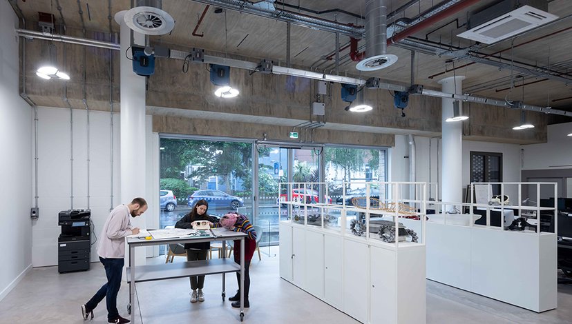 Researchers stand around models of vehicles