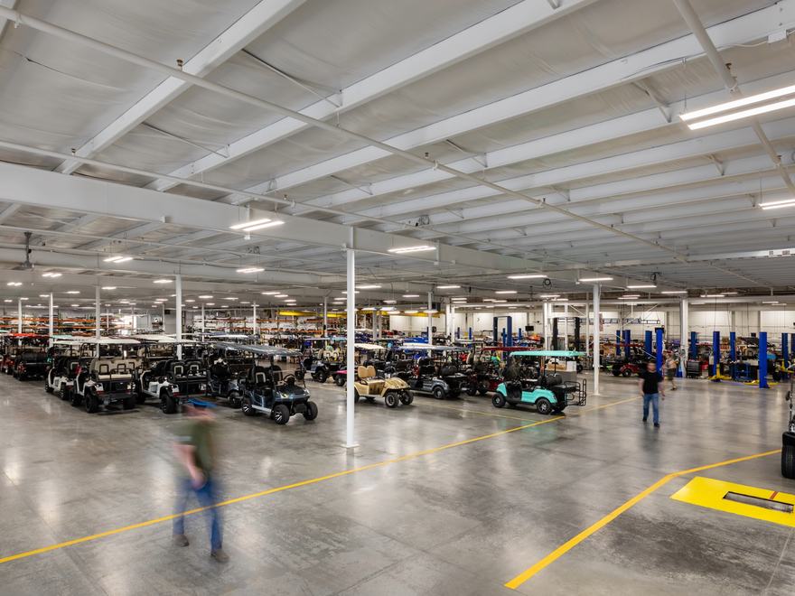 a warehouse with lots of golf buggies