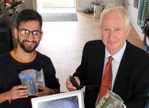 The Jolly Geographer (left) talking MP for Cambridge, Daniel Zeichner through the Ny Naturewatch hedgehog monitoring project with Wildlife Trust BCN