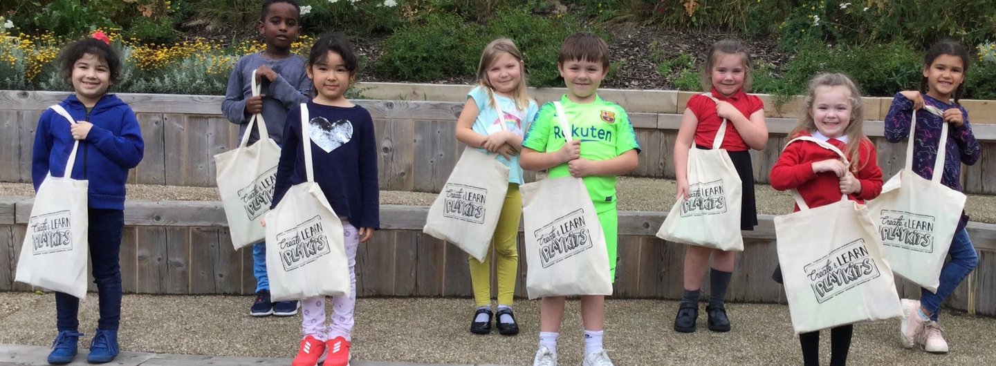 Children holding their Create & Learn PlayKit bags