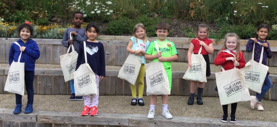 Children holding their Create & Learn PlayKit bags