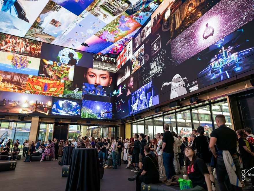 Multiple digital works displayed on an immersive screen at Outernet