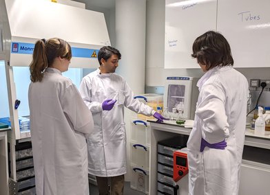 Kailash with Yuki and Rosalie explaining algae culturing technique