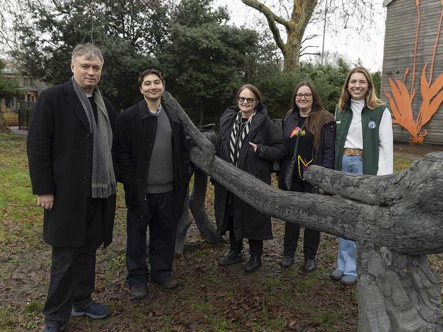 Group of people standing by the Appararition sculpture by Samuel Domínguez