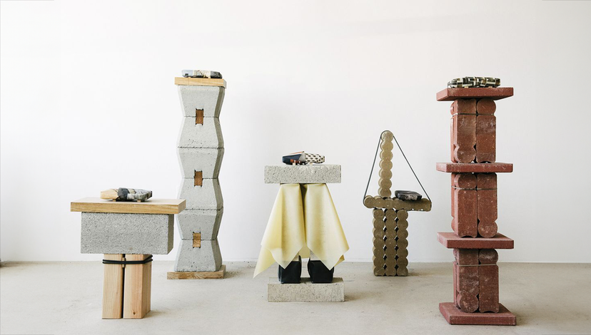 Five sculptural pieces composed of various materials, including stacked concrete blocks, wooden elements.