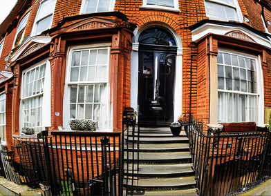 Fish eye street view of a London Victorian house through a camera lens