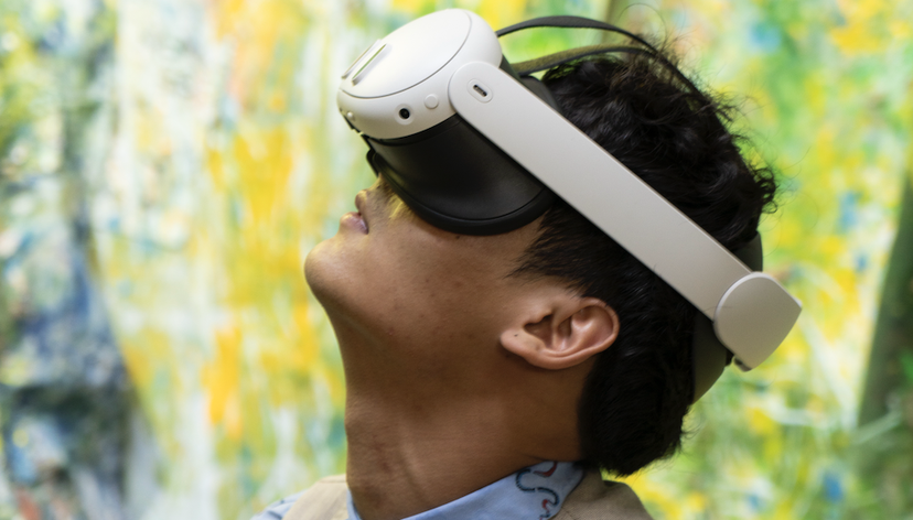 A visitor to RCA2025 uses a VR headset to experience the work on Hyunah Koh (MA Painting)