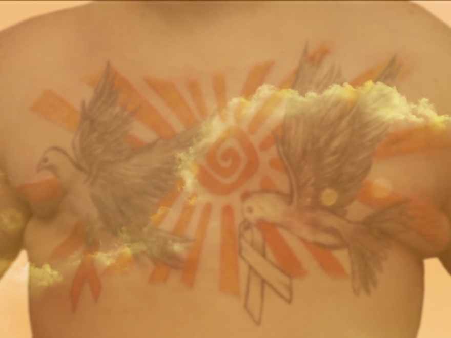A naked torso with tattoos of birds
