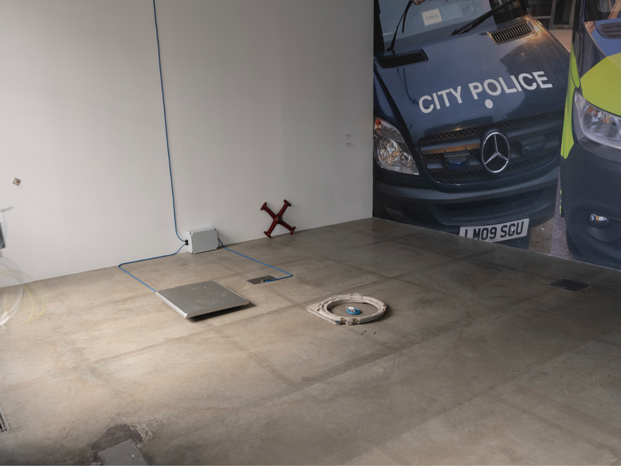 A police van with a dirty sock on the windscreen wiper