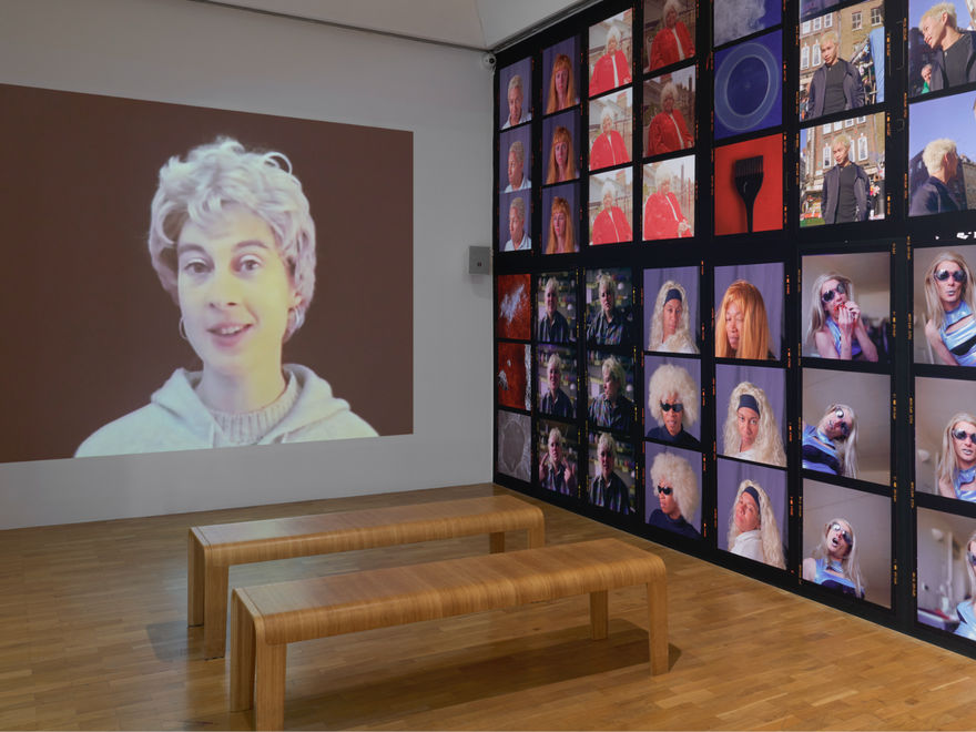 A gallery room showing many photos on the wall