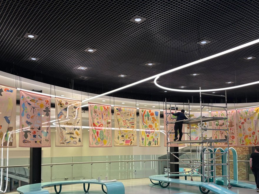 A photo of colourful banners hanging in a shopping centre