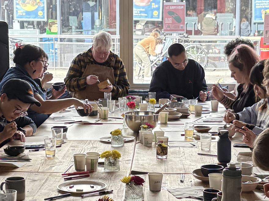people sat at a dining table with food