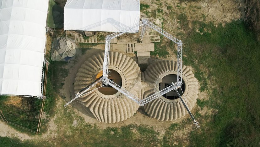 Ariel view of the construction of a Tecla house, a prototype 3D-printed eco-residential building made primarily from raw earth.