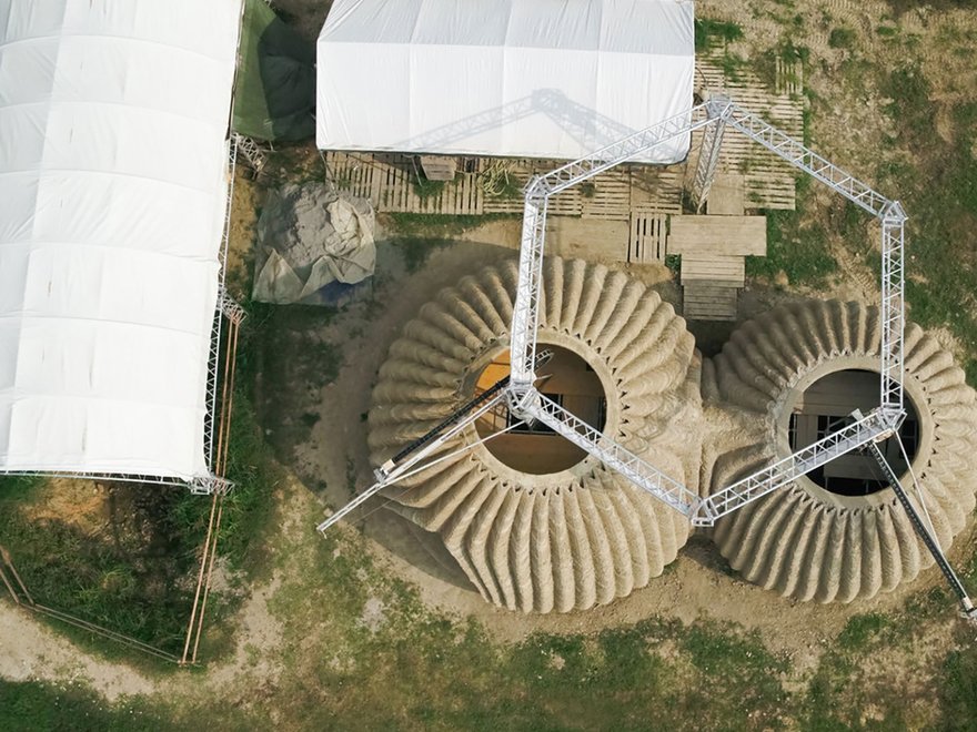 Ariel view of the construction of a Tecla house, a prototype 3D-printed eco-residential building made primarily from raw earth.