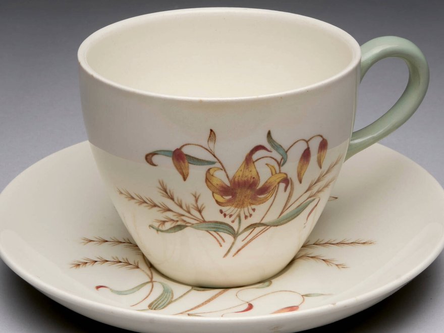 A photo of a delicate tea cup with a flower on it