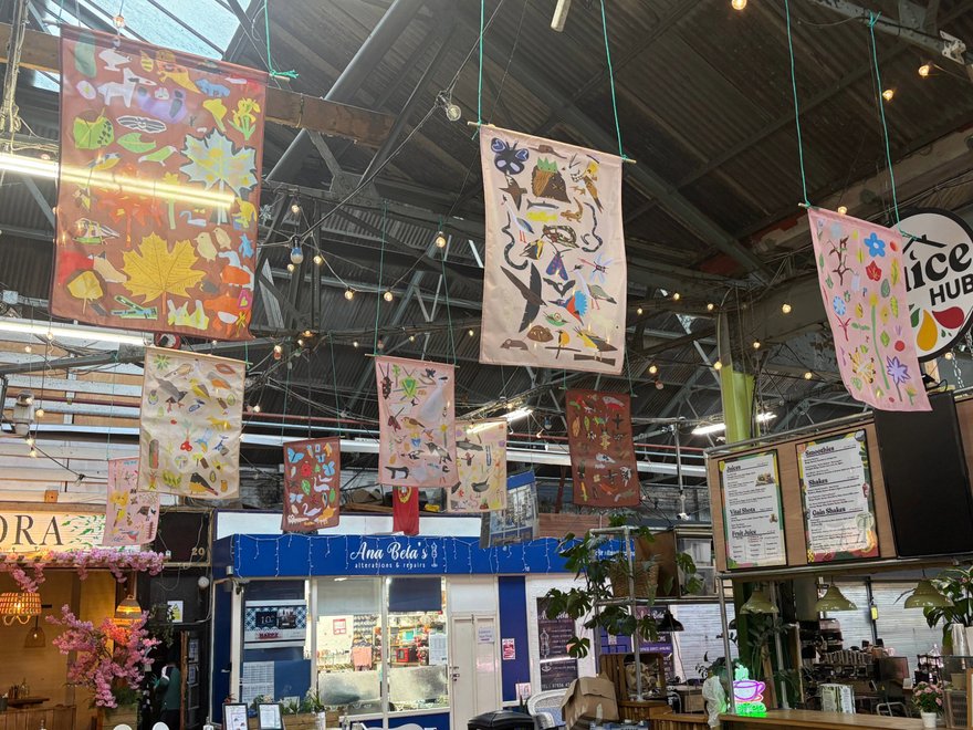 A photo of banners hanging in a market