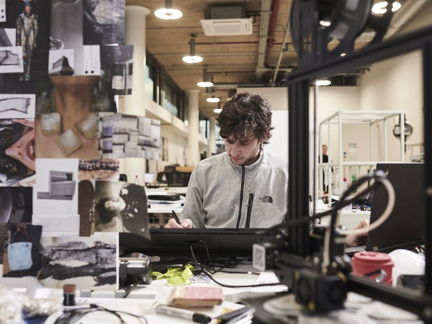 A researcher in the Intelligent Mobility Design Studio, sketching