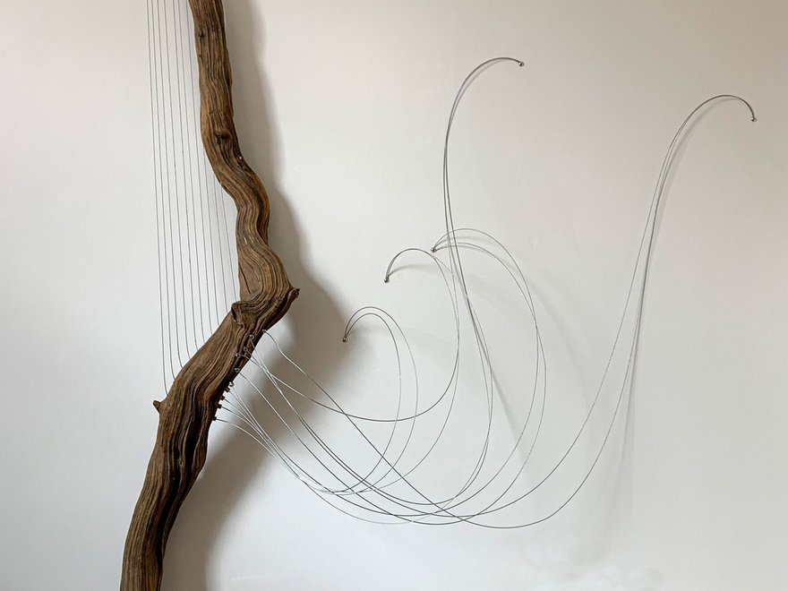 Annie Trevorah contemporary art sculpture - a log with wires held taut between it curvature, resembling a stringed instrument