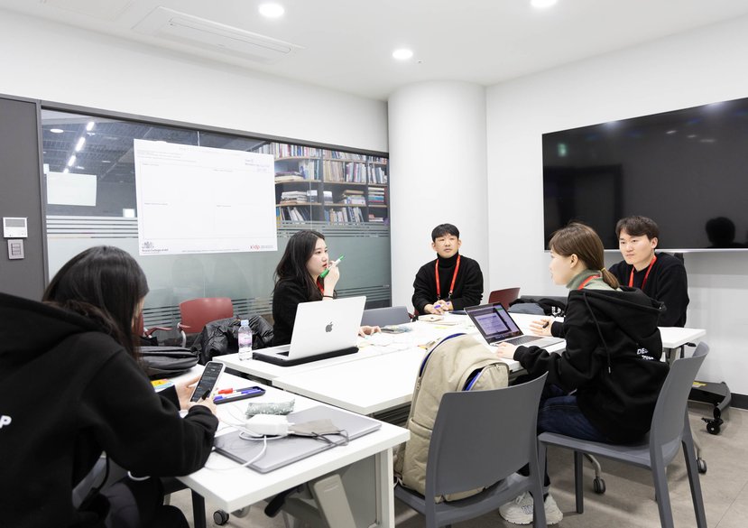 Students work in groups for a final presentation